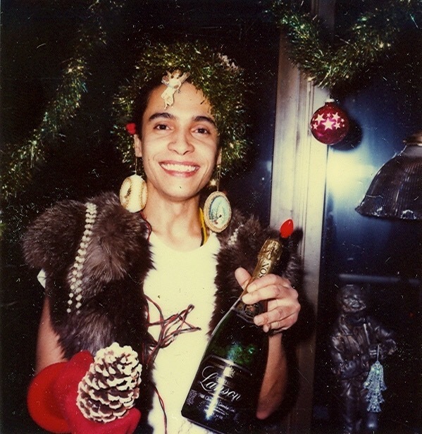 Download the full-sized image of A Photograph of Malú Rivera Wearing Tinsel and Holding Champagne