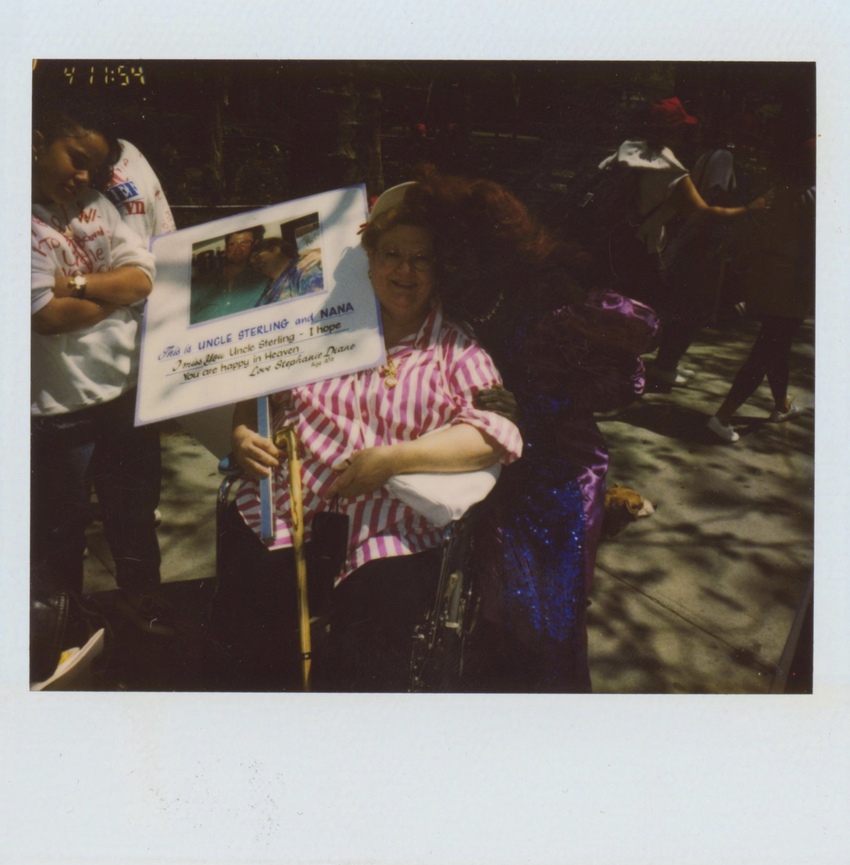 Download the full-sized image of A Photograph of Cocoa Rodriguez Posing with a Person in a Pink and White Striped Shirt