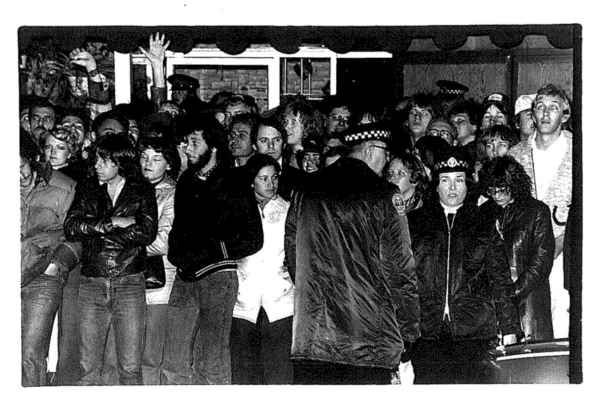 Download the full-sized image of A Police Officer Faces a Crowd in Toronto