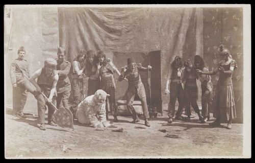 Download the full-sized image of British airforce servicemen performing a sketch, striking an animated pose. Photograph, 1918.
