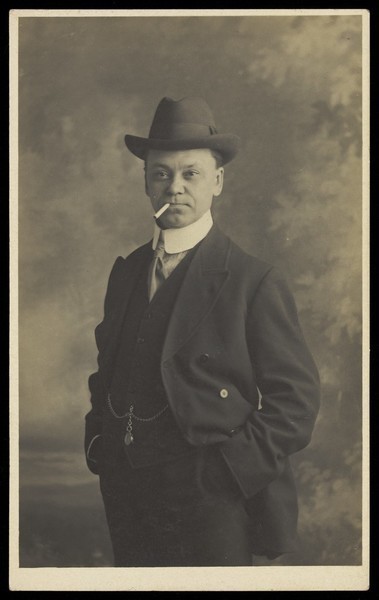 Download the full-sized image of Malcolm Scott, smoking a cigarette. Photographic postcard by J.G. Capstaff, 191-.