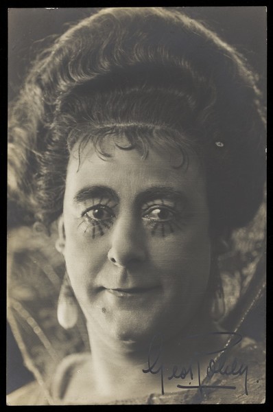 Download the full-sized image of George Robey poses in character, with sunbeam eye make-up. Photographic postcard, 191-.