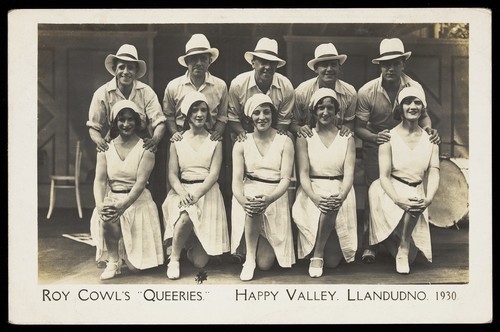 Download the full-sized image of Members of Roy Cowl's "Queeries" pose for a group portrait in Llandudno. Photographic postcard, 1930.