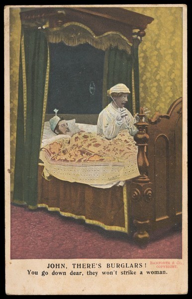 Download the full-sized image of Two men in bed, one in drag: they have been woken up by the sound of burglars. Colour lithograph, 191-.