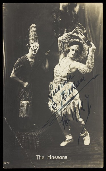 Download the full-sized image of "The Hassans" in character, performing on stage. Photographic print, 192-.